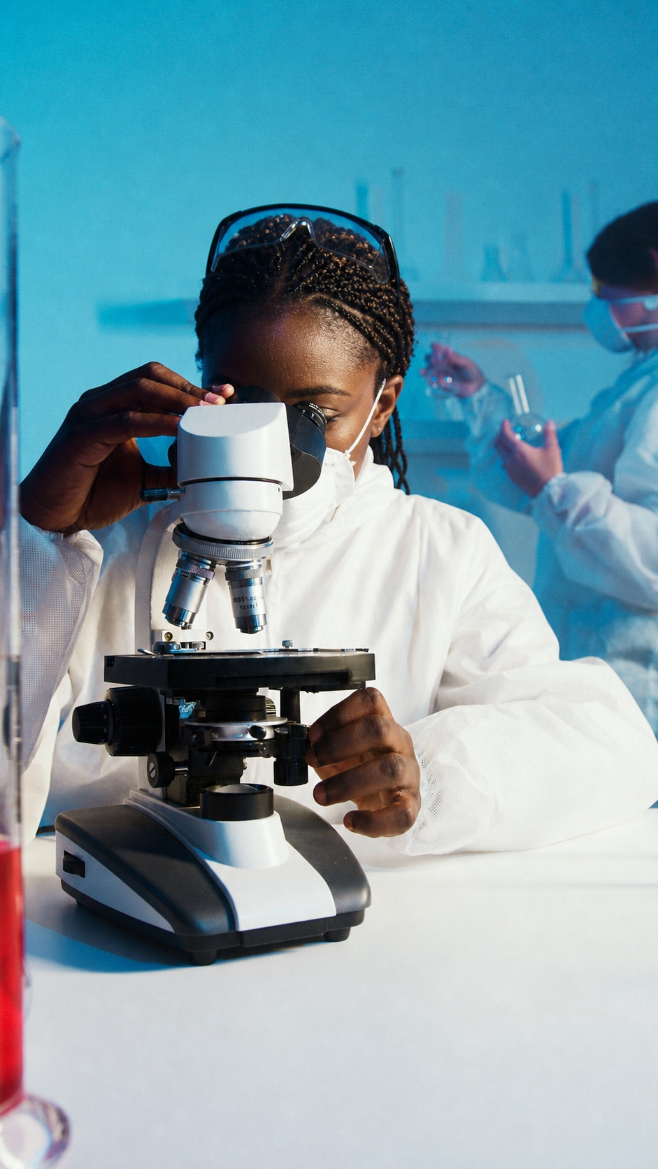 Professional scientist working at a microscope