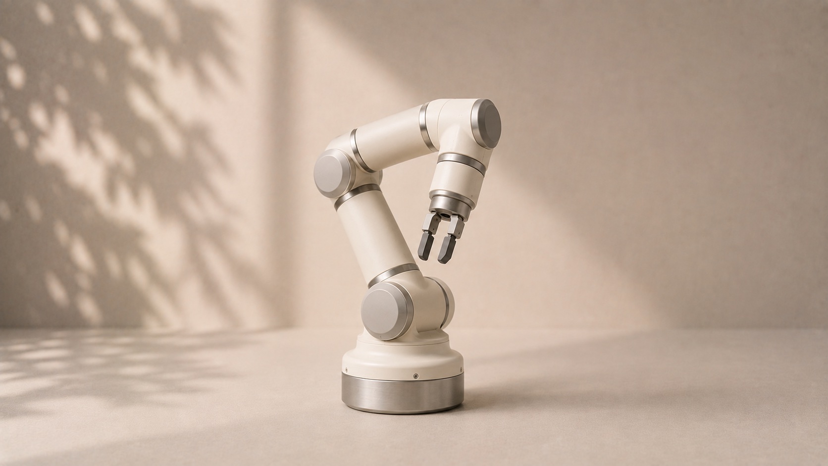 A compact collaborative robot arm with rounded joints and a small gripper.