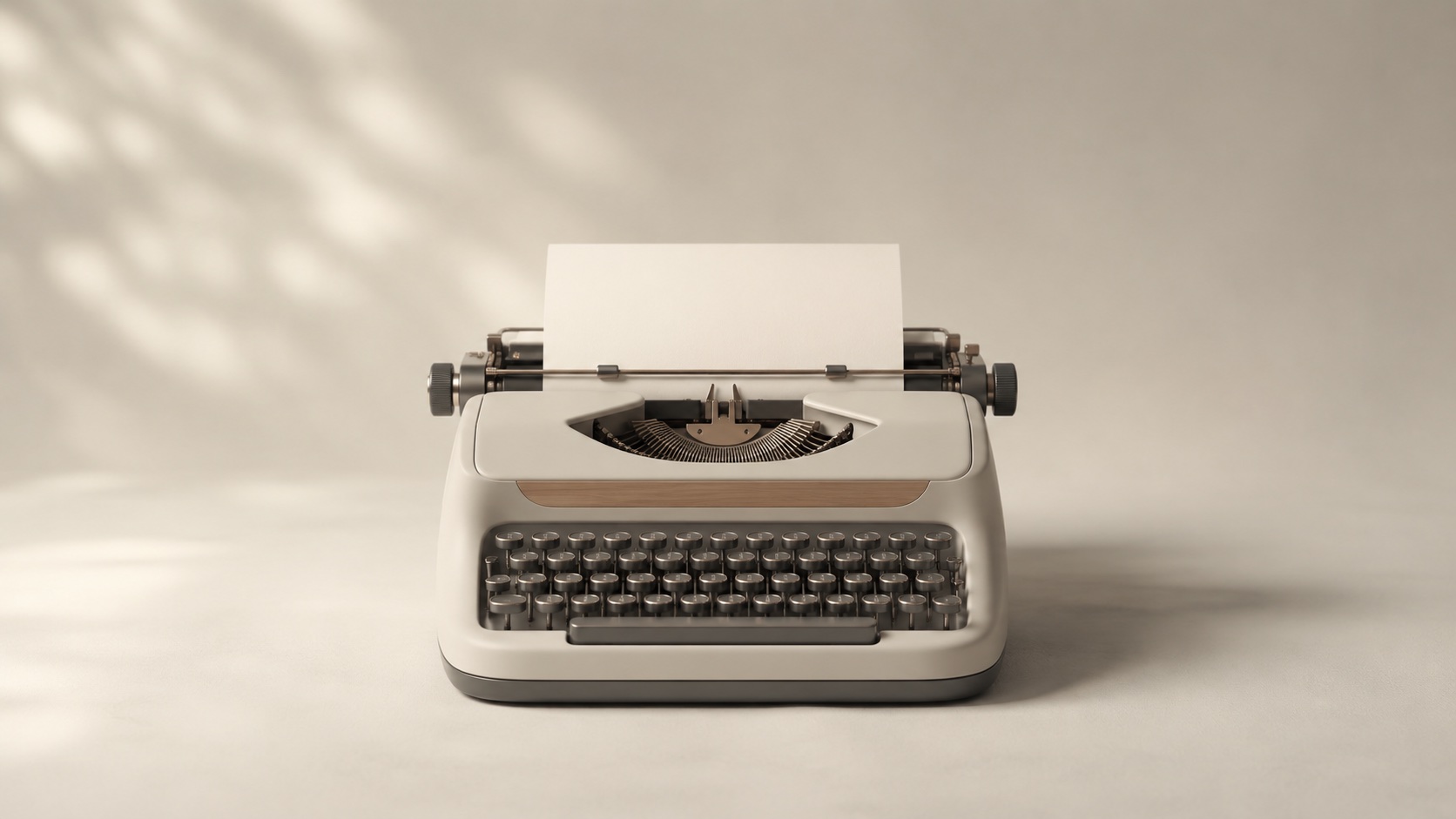 A vintage typewriter holding a blank sheet of paper.